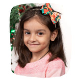 Christmas Baby Headband - Soft & Stretchable | Trendy Designs worn by a young girl with a festive red and green geometric bow, perfect for holiday photos.