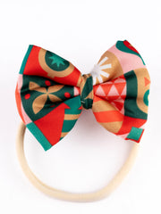 Christmas Baby Headband - Soft & Stretchable | Trendy Designs with a vibrant red, green, and gold geometric bow, ideal for toddlers and newborns.
