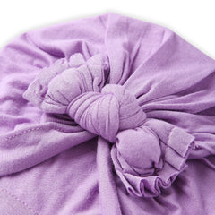 Close-up of soft cotton fabric and detailed bow knot design on purple baby turban, showcasing breathable and gentle texture for baby comfort.