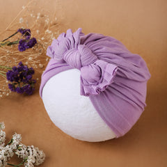Lightweight purple cotton baby turban with bow knot displayed on a mannequin, perfect hair accessory for infants aged 0 to 2 years.