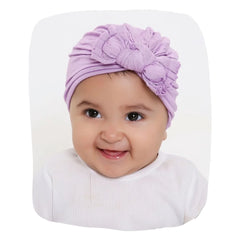 Cotton Baby Turban - Purple Knot styled on smiling baby girl, soft and breathable for newborns to toddlers, ideal for daily wear and photoshoots.