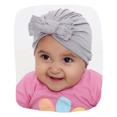 Pure Cotton Grey Bow Knot Baby Turban - Cotton Baby Turban styled on smiling baby girl, ideal for 0 to 2 years. Soft, breathable fabric for comfort.