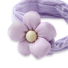 Close-up of soft lilac cotton baby headband with detailed plush flower. Stylish and gentle hair accessory for infants and toddlers.