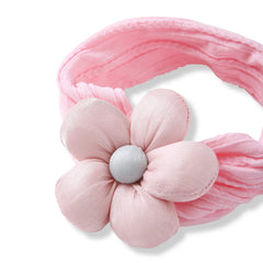 Close-up of soft pink flower cotton baby headband showing stretchable fabric and plush flower design. Comfortable and fashionable for baby girls.