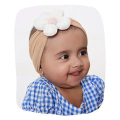 Baby wearing soft stretchable cotton headband with white flower, ideal for infants aged 0 to 2 years. Stylish and comfy hair accessory.