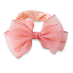 Close-up of cotton baby headband featuring a soft, stretchy band and a large double layered peach bow for infant girls.