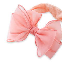 Detailed view of peach bow on cotton baby headband, showcasing soft fabric and elegant stitching for stylish baby accessories.