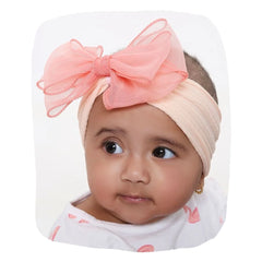 Cotton baby headband with double layered peach bow worn by infant girl, ideal for newborns and toddlers aged 0 to 2 years.