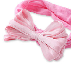 Close-up of pink double layered bow on baby cotton headband. Designed for comfort and style for infants and toddlers.