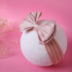 Double layered rose pink cotton baby headband displayed on a white sphere. Soft, breathable and stretchable for newborns and toddlers.