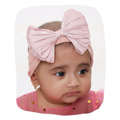Cotton baby headband bow in rose pink worn by infant girl. Double layered, soft and stretchable for ages 0-2 years, ideal for daily wear.