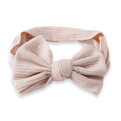 Light brown cotton baby headband with stretchable ribbed fabric and large bow knot, suitable for infants and toddlers.