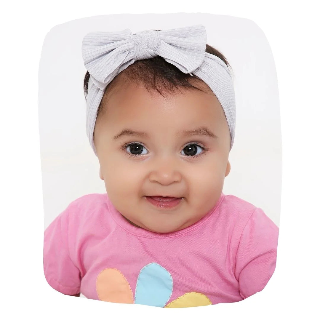 Grey Bow Knot Cotton Baby Headband on infant girl, soft stretchable fit ideal for 0 to 2 years. Stylish hair accessory for everyday wear.