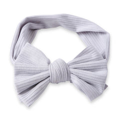 Flat lay of Grey Bow Knot Cotton Baby Headband showing ribbed texture and large bow. Stretchable and comfy for baby girls aged 0 to 2 years.