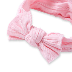 Close-up of light pink baby cotton bow headband showing detailed stitching and large bow design, perfect for infants and toddlers.