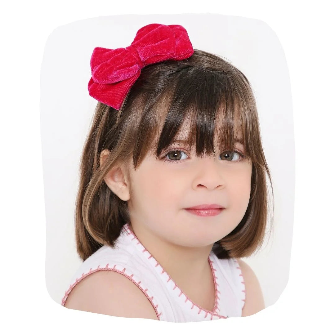 Velvet Bow Hairband - Pink Double Layered worn by a young girl, perfect for stylish kids' outfits and special occasions.