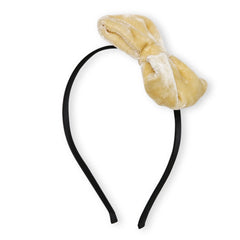 Full view of beige velvet big bow hairband with black band, designed for girls aged 3-10, combining comfort and chic style.