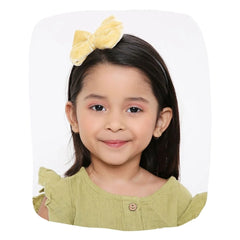 Beige velvet hairband with big bow worn by a smiling girl, ideal for kids' fashion and daily wear. Soft, stylish fit for ages 3-10.