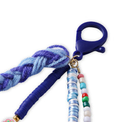 Detailed view of the Blue Fimo Bead & Star Bag Charm's clip and bead strands, showing its secure clasp and playful design.
