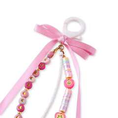 Top view of pink beaded bag charm with smiley faces, heart beads, and satin ribbon bow. Includes white clip for easy attachment to bags or keyrings.