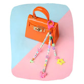 Fimo Bead Charm - Pink Multicolor Bag accessory clipped to an orange mini handbag, ideal for girls' backpacks or purses.