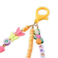 Detailed view of the clasp and beadwork on the orange personalized bag charm for kids, including fruit and butterfly designs.