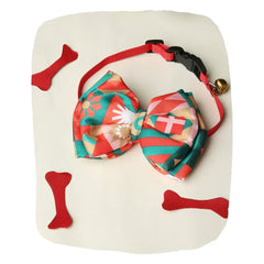 Adjustable red satin dog bow tie with geometric print and bell, displayed with red bone toys. From Red Bow Tie for Medium Dogs collection.