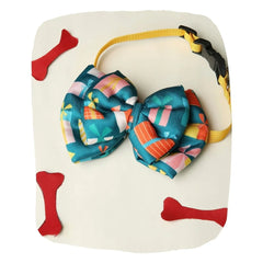 Adjustable green satin dog bow tie with vibrant gift box patterns, attached to a yellow collar. Festive pet neckwear for special occasions.