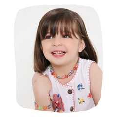 Smiling girl wearing trendy floral beaded necklace & bracelet set, showcasing vibrant Y2K-inspired jewelry perfect for teen fashion.