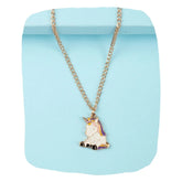 Unicorn Pendant Necklace for Girls with pink enamel charm on gold chain, displayed against a pastel blue background. Ideal kids jewelry gift.
