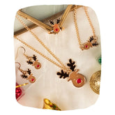 Christmas Jewelry Set - Rudolf Reindeer Design by Arendelle displayed on festive fabric with pendant, earrings, ring, and bracelet for girls.