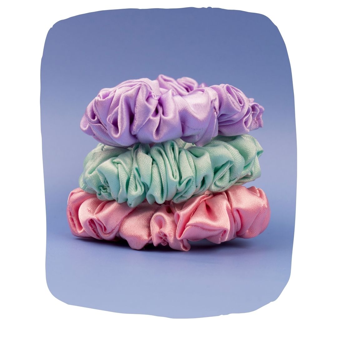 Silk satin scrunchies pack in pastel pink, mint green, and lavender, ideal for gentle, no-pull hair styling. Eco-friendly and durable hair accessories.