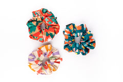 Flat lay of Arendelle Scrunchies - Christmas Pack featuring three colorful holiday designs, perfect for girls' festive looks.