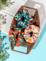 Arendelle Scrunchies - Christmas Pack of 3 displayed in a wicker tray with holiday-themed prints, ideal for festive hairstyles.
