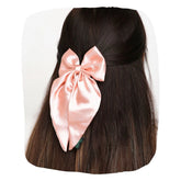 Satin Silk Hair Bow in Pastels worn on dark hair, showcasing its handmade elegance and secure fit for girls and women.