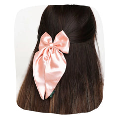 Satin Silk Hair Bow in Pastels worn on dark hair, showcasing its handmade elegance and secure fit for girls and women.