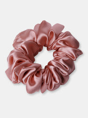 Close-up of a pink Silk Satin Scrunchie showing smooth texture and gentle fabric. Great for reducing frizz and breakage in daily hair care.