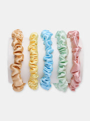 Silk Satin Scrunchies Pack displayed on a roll, featuring 5 pastel skinny hair ties for smooth, no-break styling and eco-friendly wear.