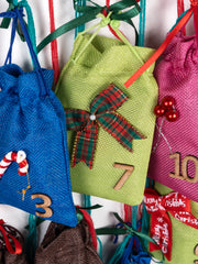 Close-up of green pouch number 7 with plaid bow on Personalized Advent Calendar for Girls, ideal for gifting hair accessories.