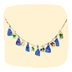 Kids' Advent Calendar - Christmas Surprises | 12-Day Fun featuring festive cloth pouches with numbers and holiday-themed hair accessories inside.