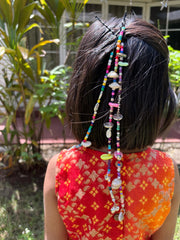 Girl wearing Navratri Beaded Tassel hair accessory with vibrant beads and shells, perfect for festive kids' hairstyles during Garba nights.
