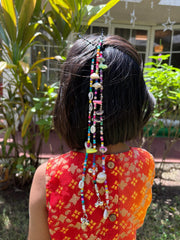 Back view of girl showcasing multiple Navratri Beaded Tassel scrunchies with colorful beads and charms, festive hair ties for kids' traditional outfits.