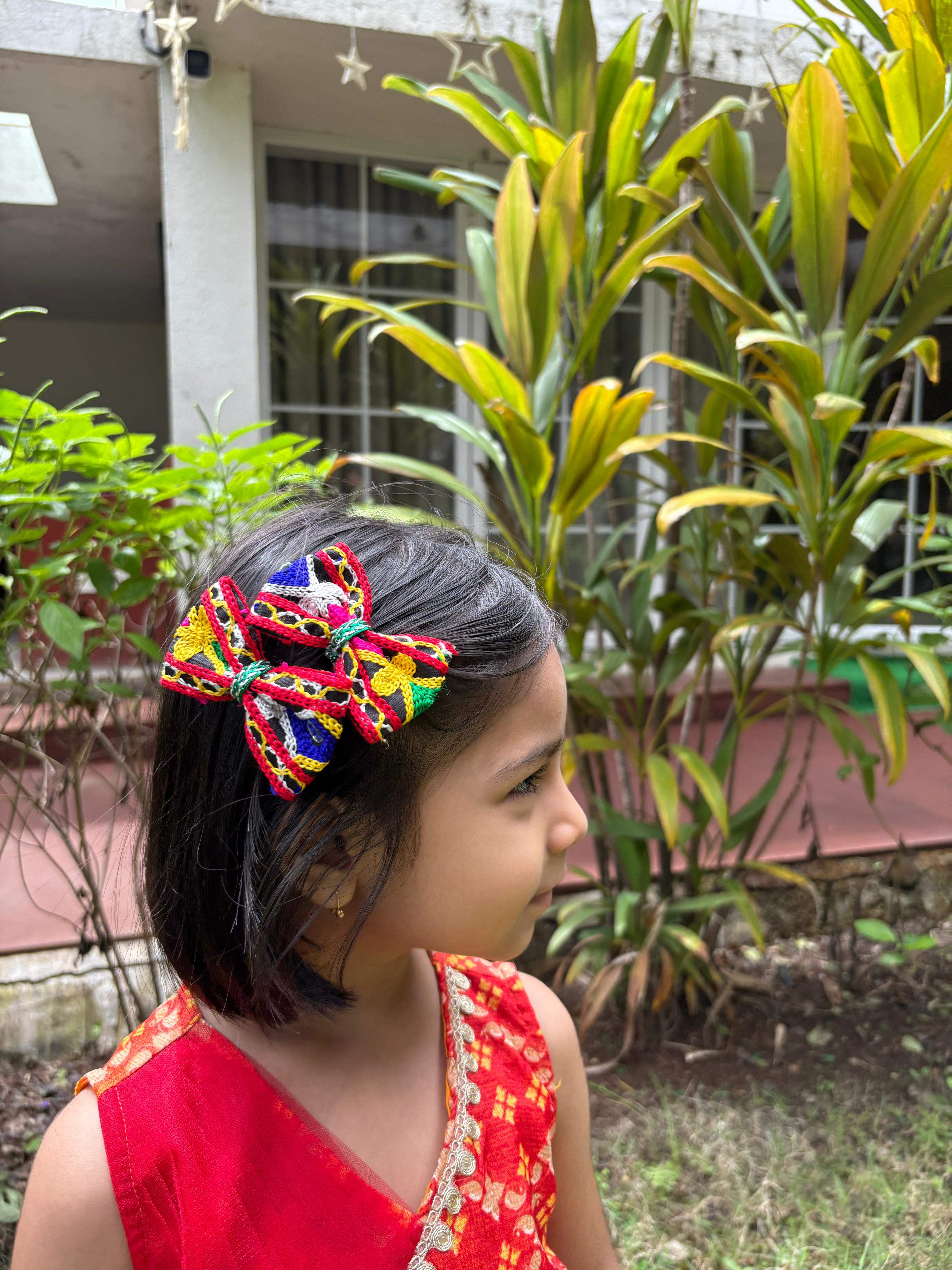 Girl wearing Rangtaari Navratri Bow Set, vibrant handcrafted hair accessories perfect for Garba nights and traditional festive outfits.
