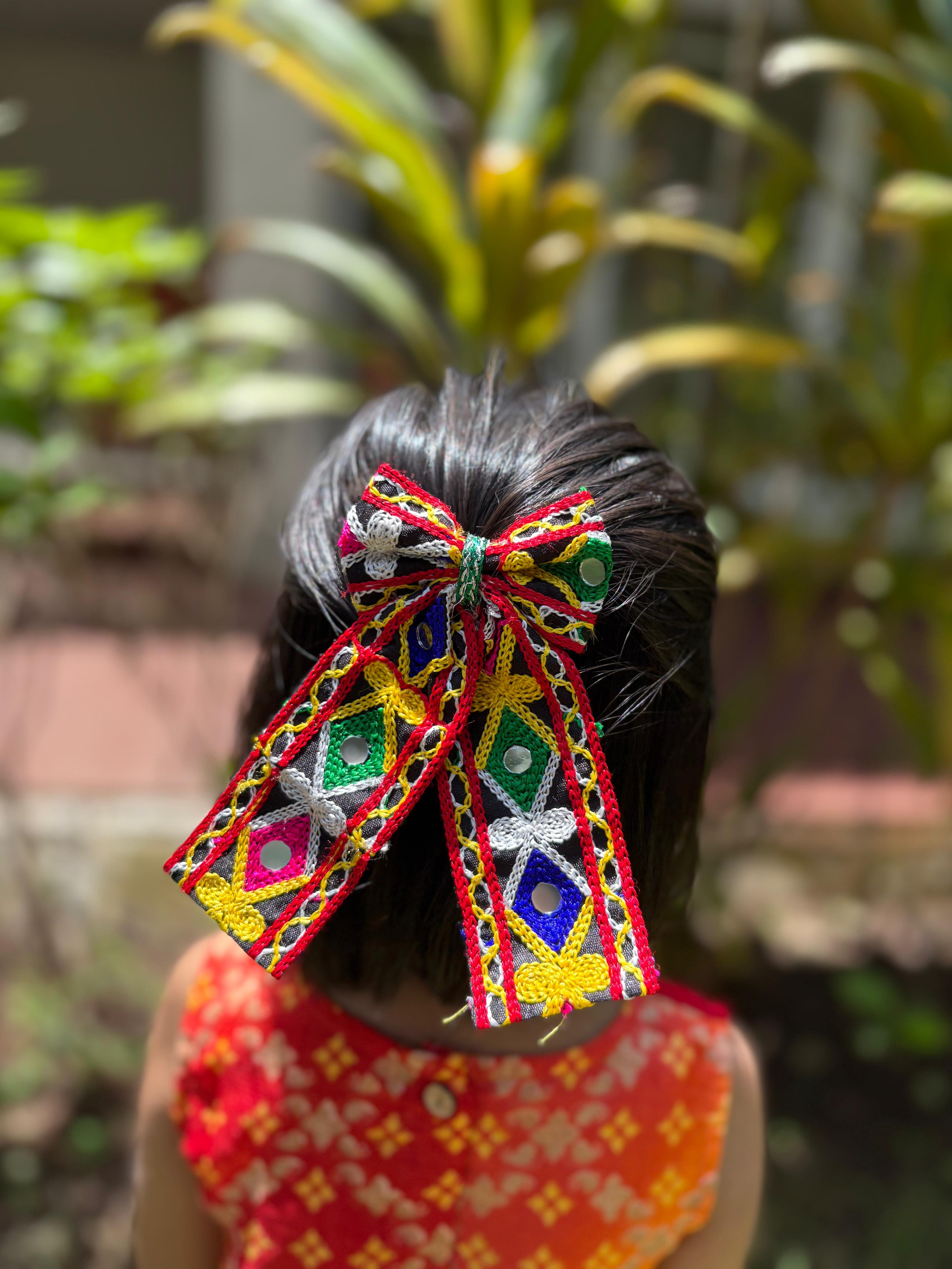 Navratri Pigtail Hair Bow for kids styled on short hair, featuring vibrant traditional embroidery perfect for festive Garba outfits.