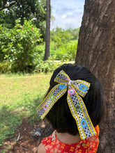 Pari Hoon Main Pigtail Bow styled on a girl's hair, perfect Navratri hair accessory for kids with colorful mirror work and lace detailing.