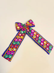 Colorful Dholida Pigtail Bow featuring traditional mirror embroidery, ideal Navratri hair accessory for girls' festive attire.