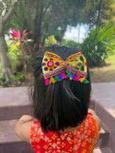 Kesariyo Tassel Bow hair accessory with vibrant embroidery and tassels, styled on a girl for Navratri Dandiya night celebration.