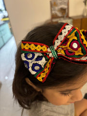 Girl wearing Chogada Hairband featuring vibrant embroidery and mirror work, ideal for traditional Navratri Garba celebrations and festive outfits.