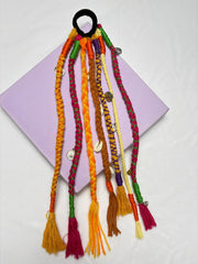 Navratri Hair Tassel Cords - Accessories | Festival Ready scrunchies in shades of brown with colorful braided tassels and metallic charms.