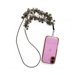 Arendelle Coins Sling - Navratri Style attached to a pink smartphone, blending festive charm with practical phone accessory design.